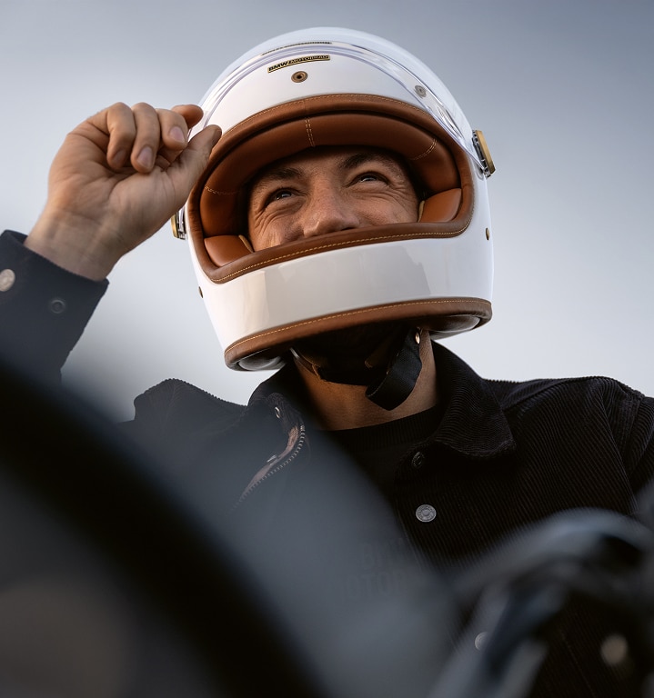 A close-up of a motorcyclist wearing a helmet.